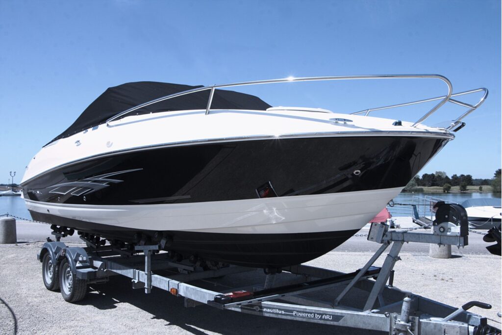 A boat on a trailer at a dock