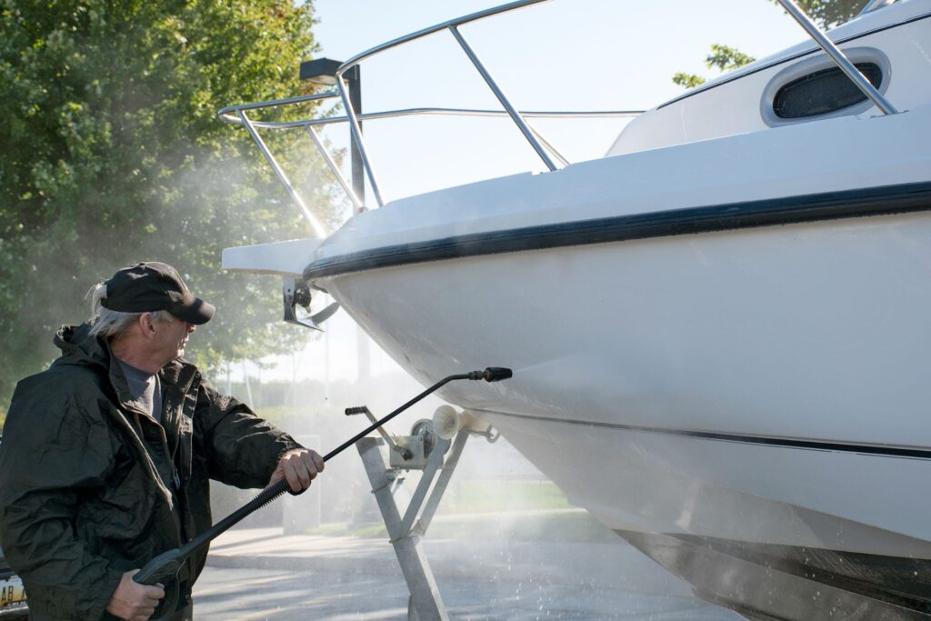 A man power washing a boat